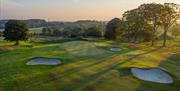 Birds eye view of the golf course at sunrise