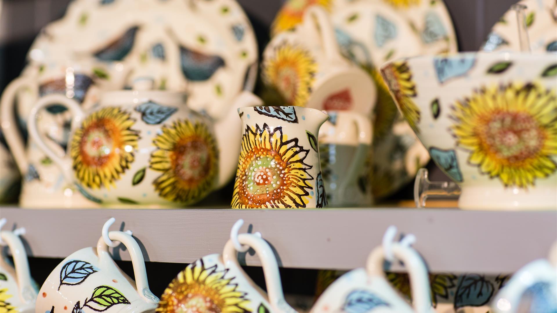 Photo of professionally painted ceramic pieces or sale with a sunflower pattern