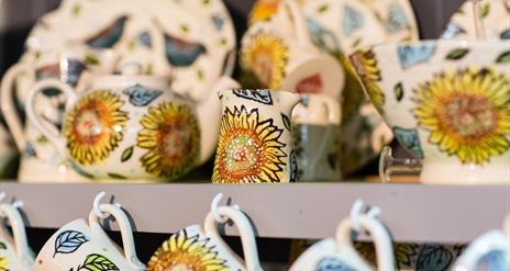 Photo of professionally painted ceramic pieces or sale with a sunflower pattern