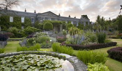 Photo of the formal gardens in colourful bloom at Mount Stewart with the Estate House in the background