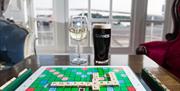 A glass of wine, pint of Guinness and a game of scrabble in the seating area