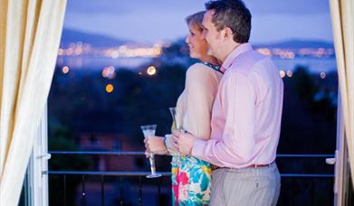 A couple enjoying the view from a balcony