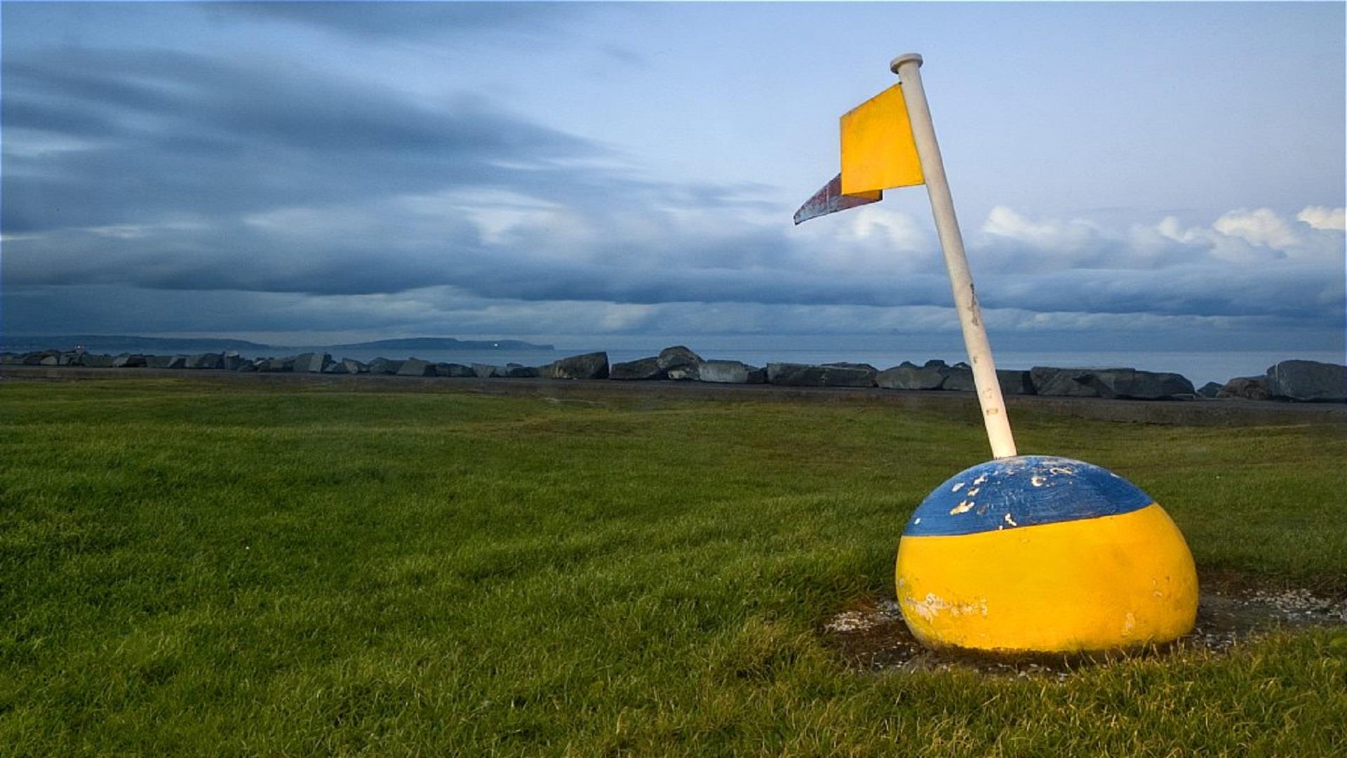 Photo of flagged bouy set out as decor at Ballyholme near the pitch and putt facility, overlooking the bay