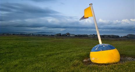 Photo of flagged bouy set out as decor at Ballyholme near the pitch and putt facility, overlooking the bay