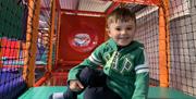 Boy Smiling for Camera in Soft Play Frame
