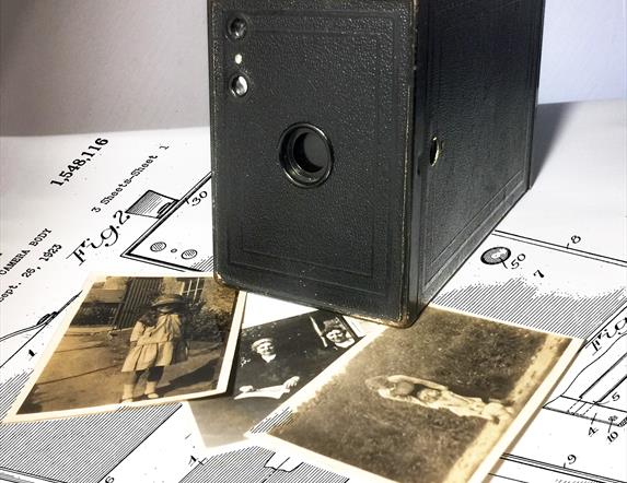 Old fashioned camera with photo's of the era