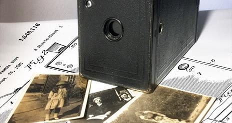 Old fashioned camera with photo's of the era