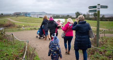 Family walking along a path on the Castle Espie reserve