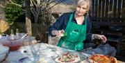 Tracey making pizzas ready to go into her garden pizza oven