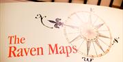 Sign displaying the words The Raven Maps