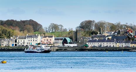 A photo of the picturesque view of Portaferry town from Strangford Lough. The Strangford Ferry is in the shot.