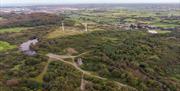 An aerial photo of Whitespots Country Park showing the wind turbines on site and the remnants of the old windmill