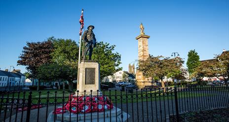 Photo of the Rollo Gillespie Monument standing tall in the centre of Comber Square