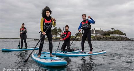 A group enjoying Stand Up Paddleboarding on Strangford Lough