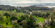 Birds eye view of Grey Abbey in Greyabbey with Strangford Lough in the background.