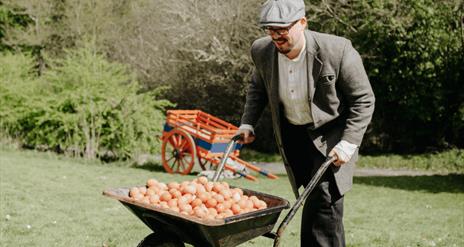 a man pushing a cart of eggs for an easter egg hunt