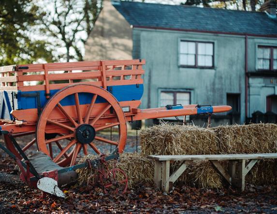 A wagon and hay bales set in Ballycultra Village in Ulster Folk Museum