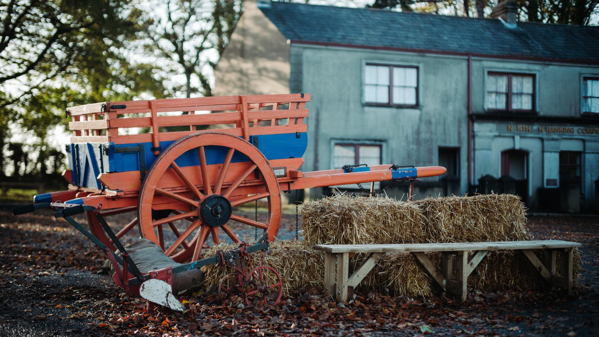 A wagon and hay bales set in Ballycultra Village in Ulster Folk Museum