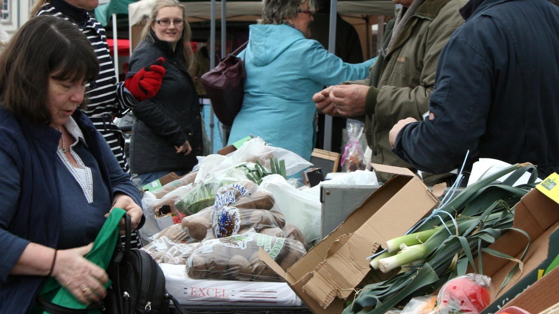 photograph showing traders and customers at the comber farmers market