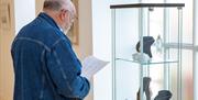 A man viewing exhibition pieces at Ards Arts Centre