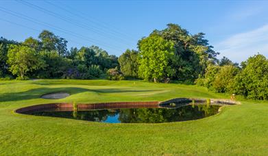 A water hazard, bunker and green at Clandeboye Golf Club.