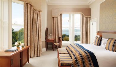 image of double bedroom with 2 large windows with views out over Belfast Lough